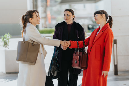Three women meeting for a networking event exchanging greetings