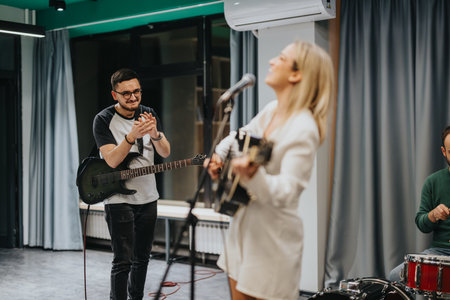 A group of musicians practicing in a studio, focusing on creative collaboration and musical...