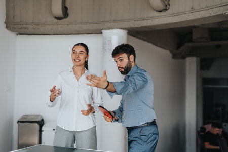 Business coworkers enjoying a friendly table tennis game at office