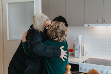 Heartwarming embrace between an elderly lady and a family member in a cozy kitchen setting