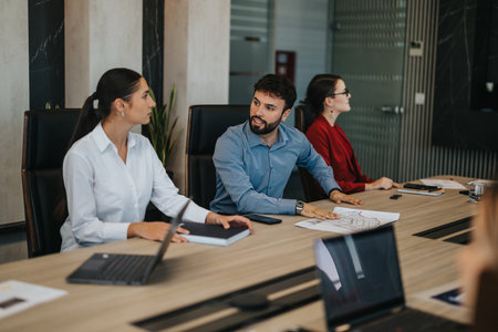 Multiracial business team engages in detailed strategic meeting