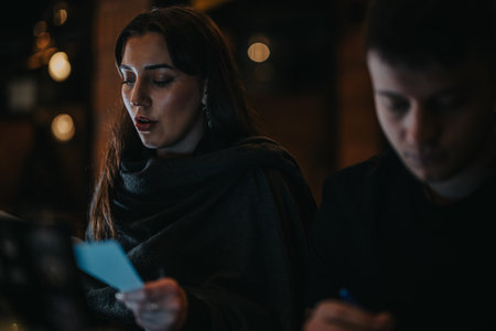 Focused people reading documents in a dimly lit cozy environment