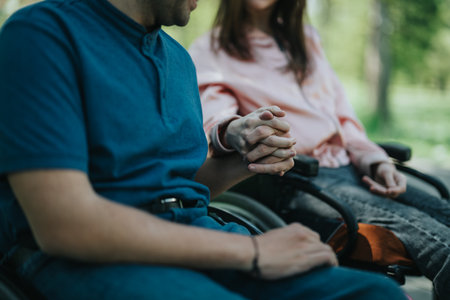 Couple holding hands and sitting together outdoors, showing connection and mutual support