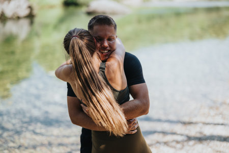 Couple embracing near a river in a natural outdoor settingの写真素材