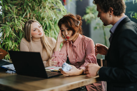 Business team discussing project at outdoor cafeの写真素材