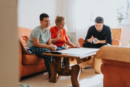 Family playing board games together in a cozy living roomの写真素材