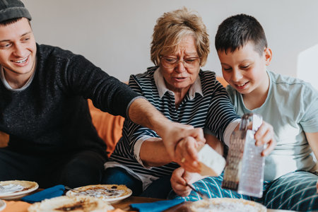 Senior woman enjoying quality time with her family, making and serving delicious pancakes in a warm and joyful home setting.の写真素材