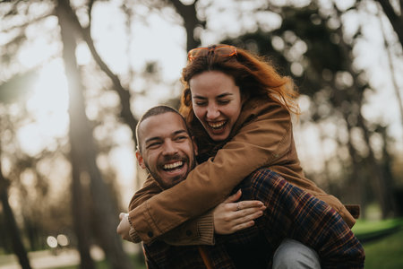 Young couple sharing a joyful playful moment together in an outdoor park settingの写真素材