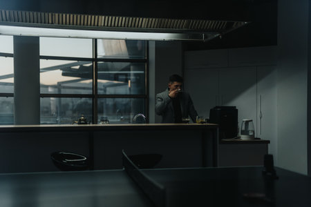 Businessman enjoying coffee break in modern office kitchenの写真素材