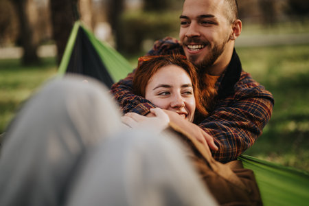 Happy couple embracing outdoors in a green park settingの写真素材