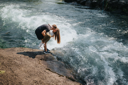 Couple Embracing Outdoors Near a Flowing River Landscapeの写真素材