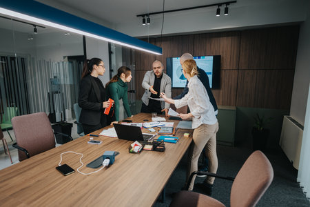 Group of employees strategizing in a modern office conference room during a business meeting discussionの写真素材
