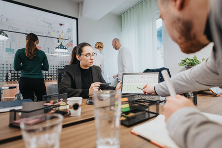 Colleagues collaborating on a financial analysis in a modern office setting