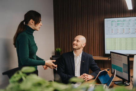 Professional business discussion between colleagues in a modern office environmentの写真素材