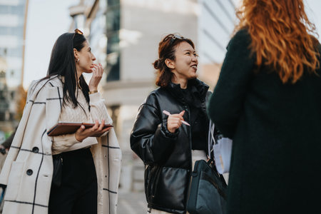 Group of women having a lively discussion in a city environmentの写真素材