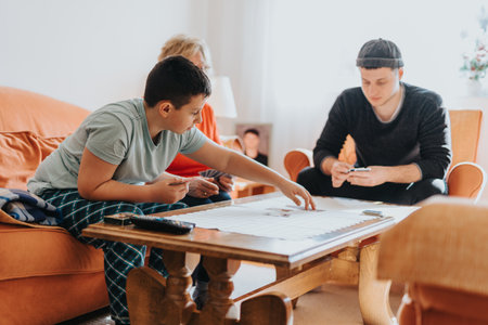 Family Gathered Around a Coffee Table Bonding Over a Game Sessionの写真素材