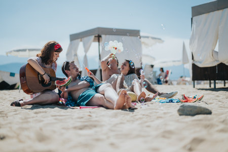 Group of friends enjoying beach activities with music and laughter under the sunの写真素材