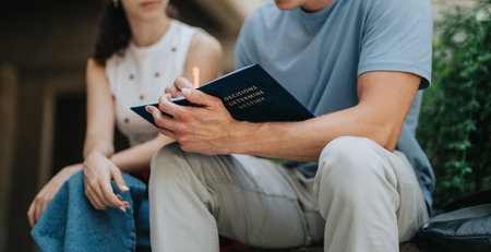 Students discussing notes and planning a project in an outdoor settingの写真素材