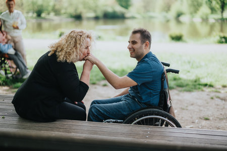A joyful outdoor moment featuring a cheerful interaction between individuals promoting warmth, support, and communityの写真素材