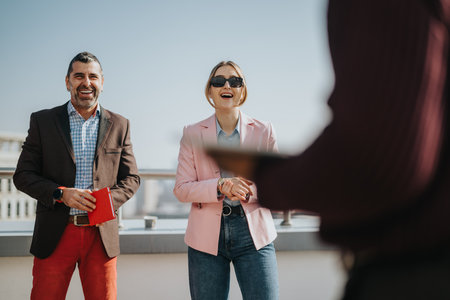 Business people meeting outdoors, sharing a lighthearted discussion.の写真素材