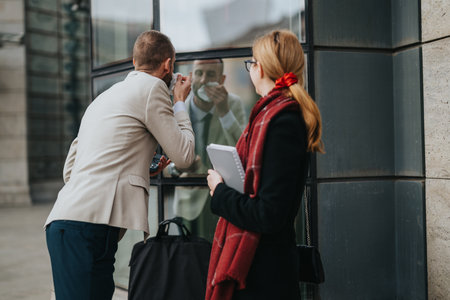 Professional business people discussing work outdoors in urban environmentの写真素材
