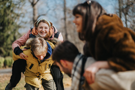 Group of friends playing outdoors and having fun during autumnの写真素材