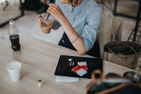 Woman at table with beverages and related items