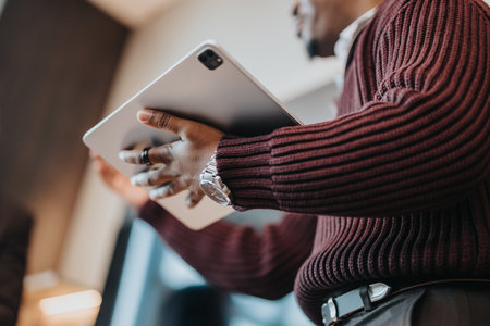 Close-up of a professional holding a tablet during a business presentationの写真素材