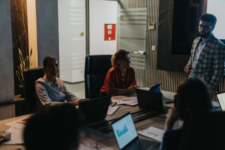 Business team collaborating on project during late night office meetingの写真素材