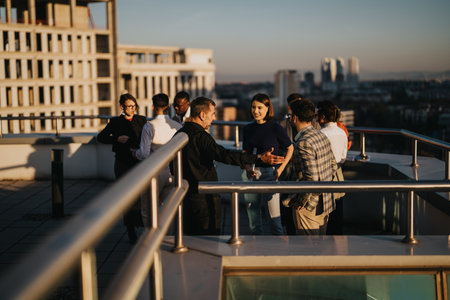 Diverse colleagues brainstorming on a rooftop at sunset in urban setting