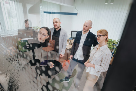 Business team brainstorming ideas together in a modern office settingの写真素材