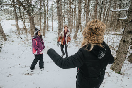 Group of friends enjoying a winter day playing in the snowy forest
