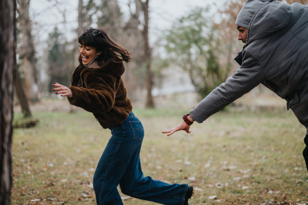 Young friends playing and enjoying a fun outdoor autumn day togetherの写真素材