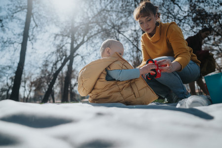 Mother and baby enjoying quality time outdoors in a sunny parkの写真素材