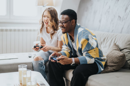Playful couple enjoying a video gaming session in their cozy living roomの写真素材
