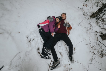 Two friends lie together in the snow, enjoying the winters serene beauty