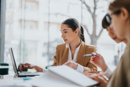 Professional women collaborating in a business meeting at an office settingの写真素材