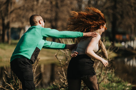 Young couple enjoying playful moments together in a park settingの写真素材