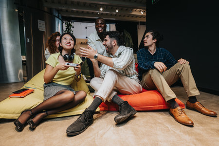 Casual discussion and teamwork in an office loungeの写真素材