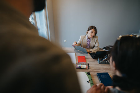 Young couple seeking financial advice from a bank adviser about loans and optionsの写真素材