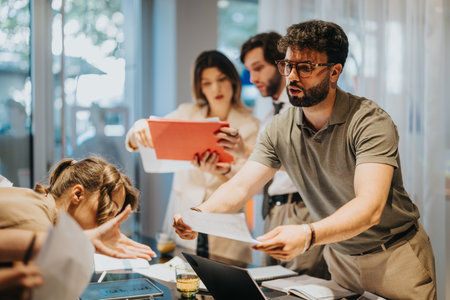 Dynamic team collaborating on a project in a modern office settingの写真素材