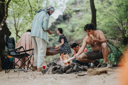 Group camping in nature with campfire and outdoor activitiesの写真素材