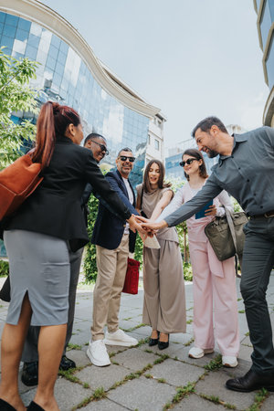 Colleagues united in teamwork in modern urban outdoor workplace environment