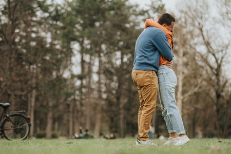 Young couple embracing warmly outdoors in a scenic natural park setting