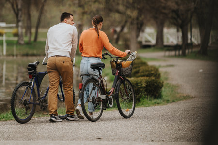 Young couple enjoying a peaceful moment with bicycles in the park