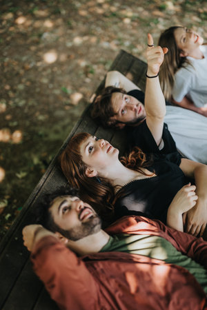 Group of friends relaxing in nature and watching the sky