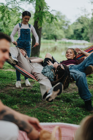 Group of friends enjoying leisure time together in a vibrant park settingの写真素材