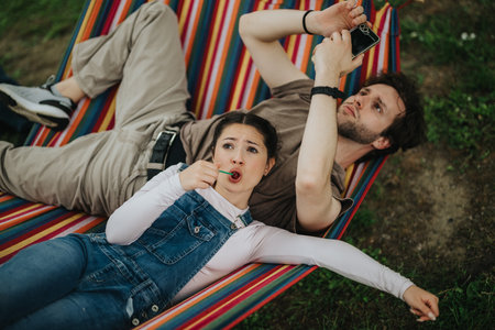 Friends relaxing together in a hammock on a calm afternoon outdoors