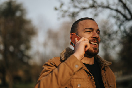 Man enjoying a phone conversation in a relaxing outdoor setting
