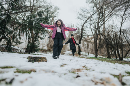 Two friends enjoying a snowy day outdoors in a nature setting with excitement and joy